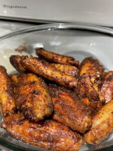 Wings in a bowl after oil and rub, but raw before being