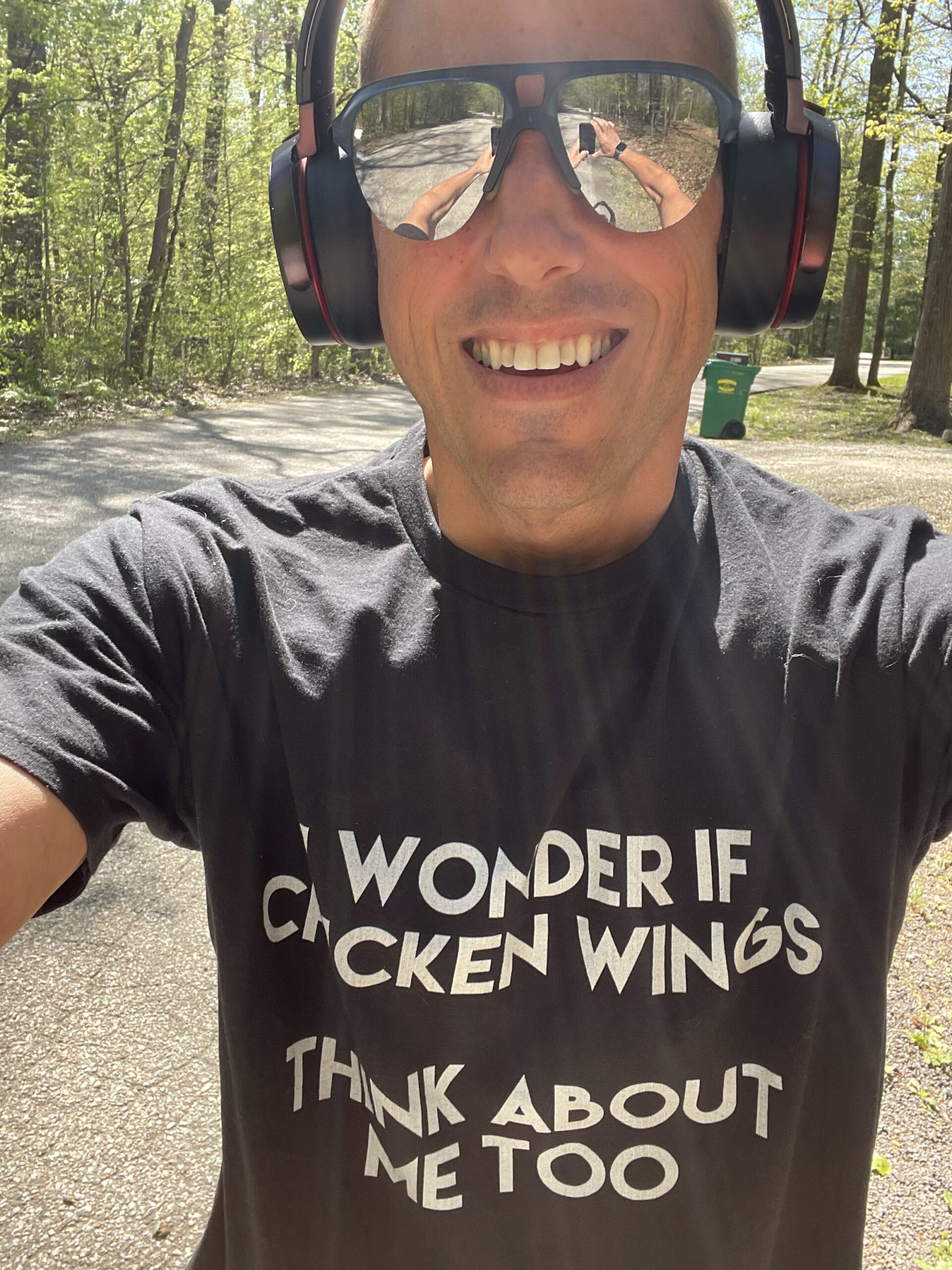 Nick wearing a shirt that says, "I wonder if chicken wings think about me, too?"